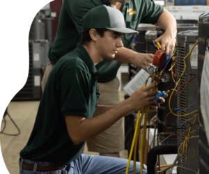Comfort Expert HVAC Tech working with a team member on an ac unit