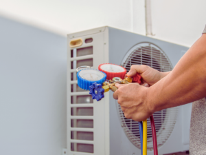 HVAC tech testing refrigerant levels to see if they are low