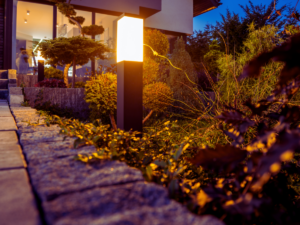 outdoor lighting on walkway helps guide guests into home