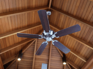 dark brown ceiling fan attached to wood panel ceiling not using a lot energy