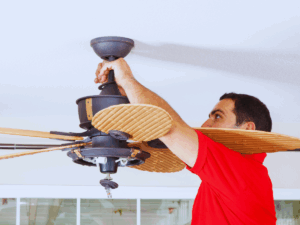 electrician properly installing ceiling fan so it will last a long time