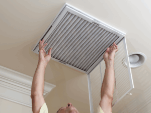 homeowner replacing AC air filter