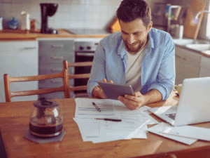 happy homeowner calculating electricity bill 