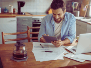 happy homeowner calculating electricity bill 
