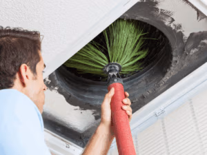 HVAC tech cleaning dirty air ducts that haven't be cleaned very often