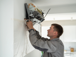 HVAC tech repairing leaking mini split 