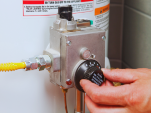 Homeowner adjusting water heater temperature 